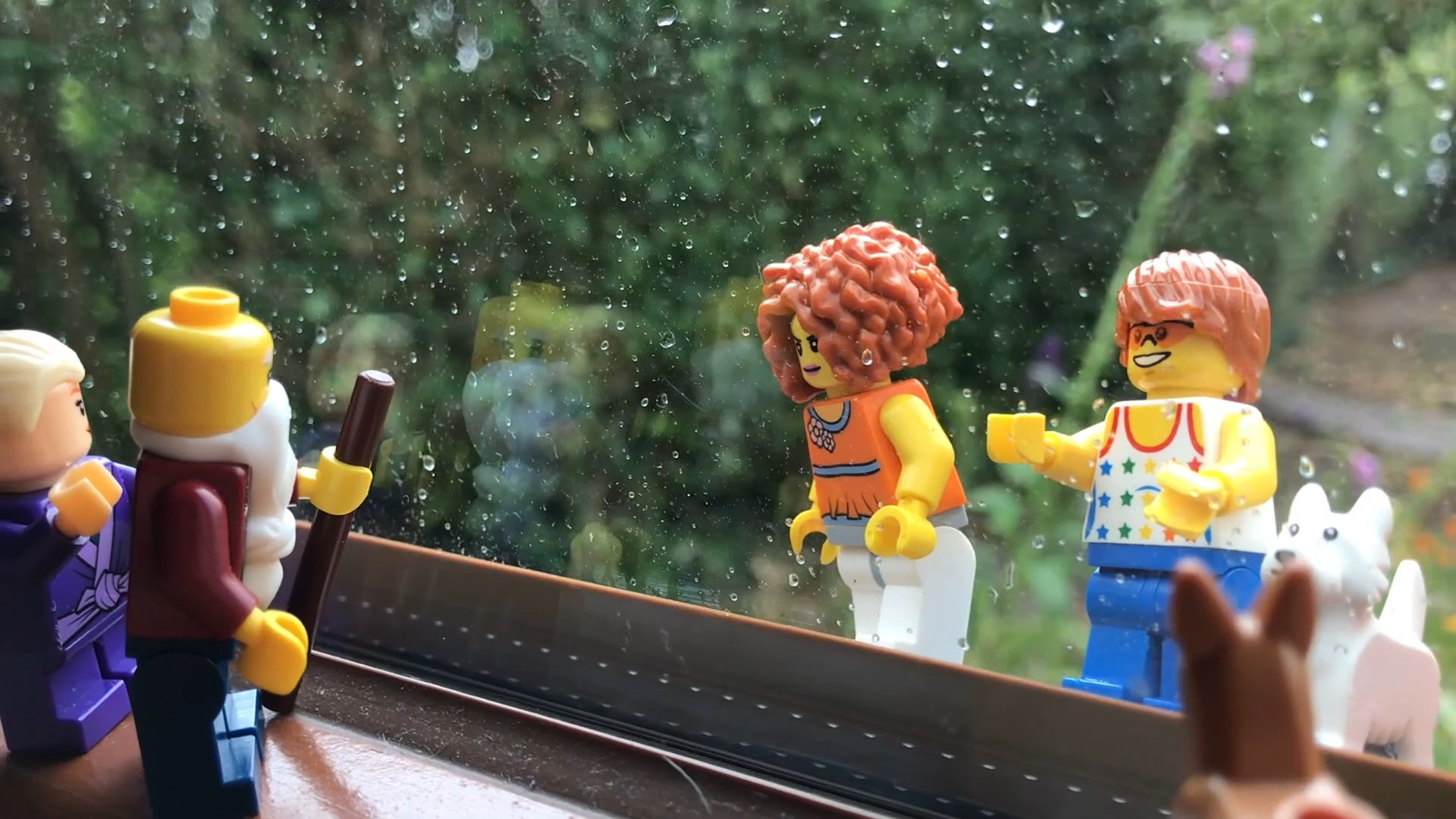 Lego scene set between a window pane.