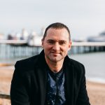 Headshot of Stuart Waters with Eastbourne Pier in the background
